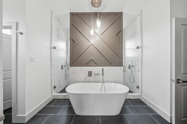 bathroom with baseboards, a freestanding bath, and a marble finish shower