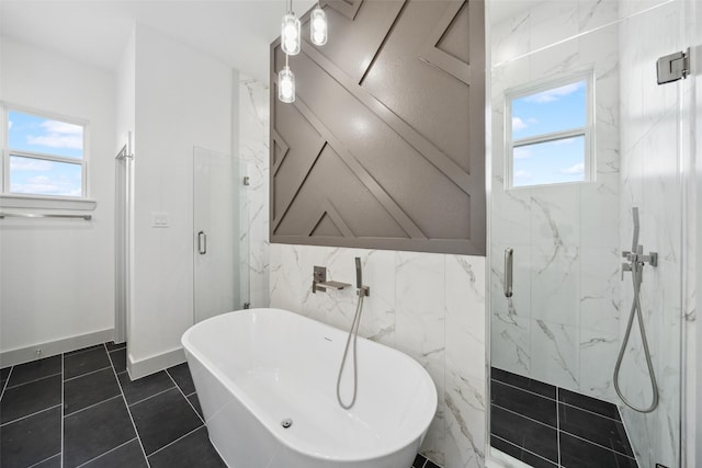 full bathroom with a freestanding bath, plenty of natural light, and a marble finish shower