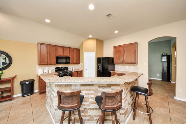 6822 Oaken Gate Way, Humble, TX 77338 - kitchen featuring black appliances, light countertops, arched walkways, tasteful backsplash, and recessed lighting
