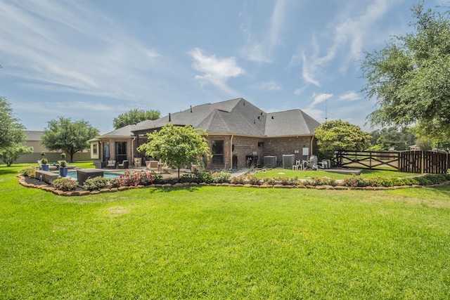 back of house with fence, brick siding, central AC unit, a patio area, and a lawn