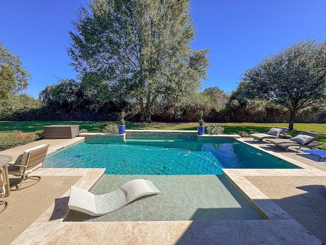 outdoor pool featuring a yard and a patio