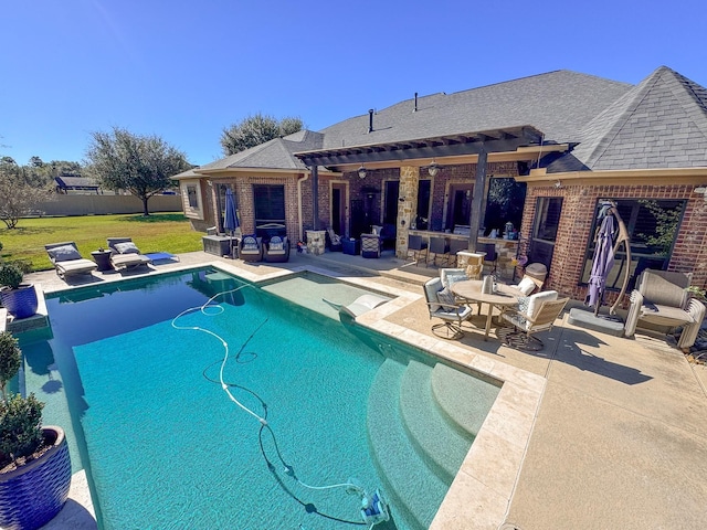 view of swimming pool featuring a fenced in pool, a lawn, and a patio area