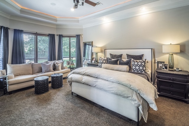 carpeted bedroom featuring visible vents, ornamental molding, and a tray ceiling