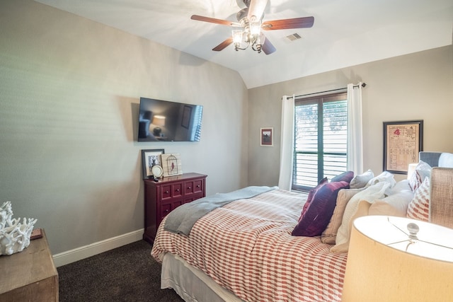 bedroom with ceiling fan, dark carpet, baseboards, lofted ceiling, and visible vents