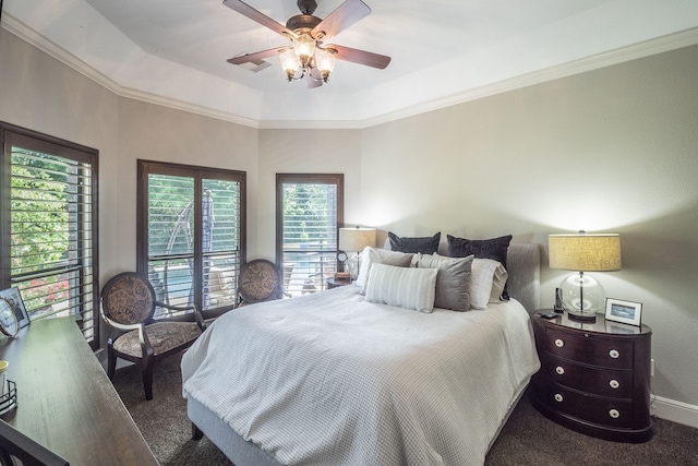 bedroom featuring carpet floors, ornamental molding, a raised ceiling, and a ceiling fan