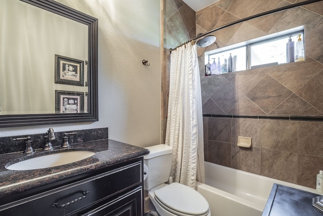 full bathroom with vanity, a textured wall, toilet, and shower / tub combo with curtain