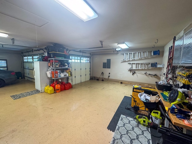 garage featuring freestanding refrigerator and electric panel
