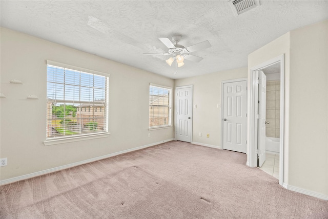 7824 Stoneyway Dr, Houston, TX 77040 - unfurnished bedroom featuring connected bathroom, carpet floors, a textured ceiling, baseboards, and visible vents