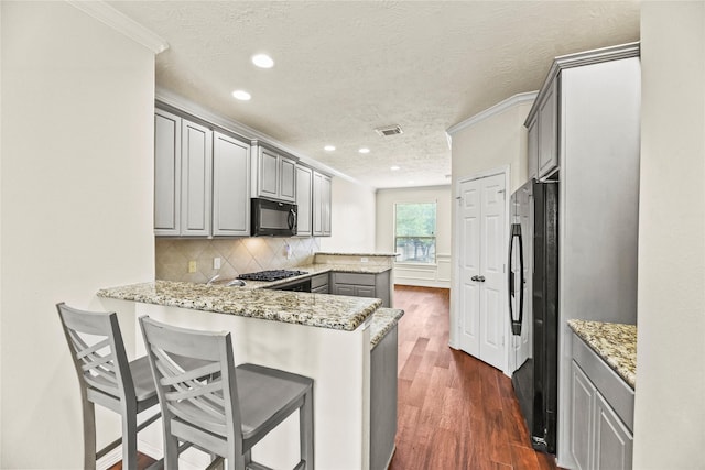 7824 Stoneyway Dr, Houston, TX 77040 - kitchen with ornamental molding, a peninsula, a textured ceiling, black appliances, and gray cabinetry