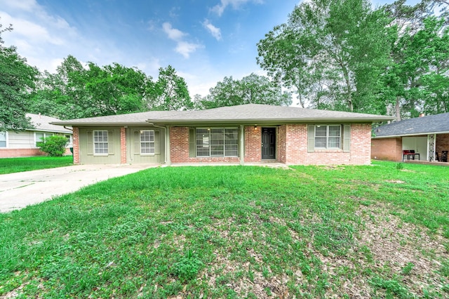 ranch-style house with a front lawn and brick siding