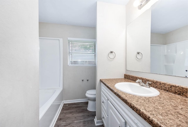 bathroom with a shower, wood finished floors, vanity, toilet, and a tub to relax in