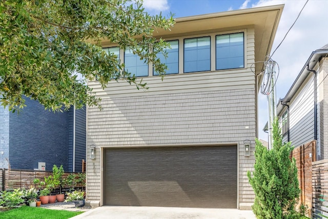 exterior space featuring concrete driveway and a garage