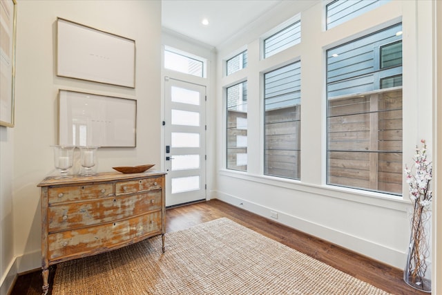 entryway featuring baseboards and wood finished floors