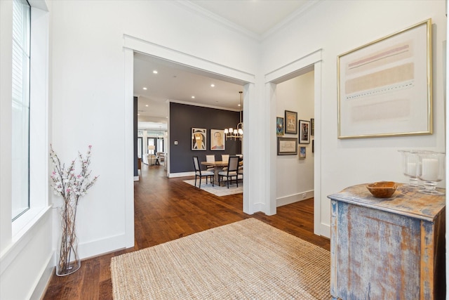 hall featuring crown molding, recessed lighting, baseboards, and wood finished floors