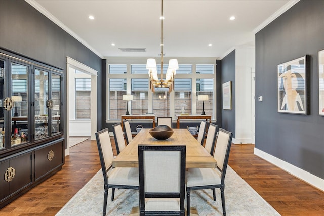 dining room featuring visible vents, dark wood-style floors, a notable chandelier, ornamental molding, and recessed lighting