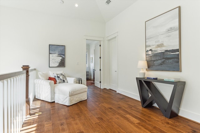 sitting room featuring baseboards, visible vents, and wood finished floors
