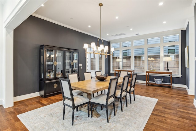 dining room featuring crown molding, wood finished floors, baseboards, a notable chandelier, and recessed lighting