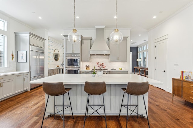 kitchen featuring backsplash, appliances with stainless steel finishes, custom exhaust hood, and gray cabinetry