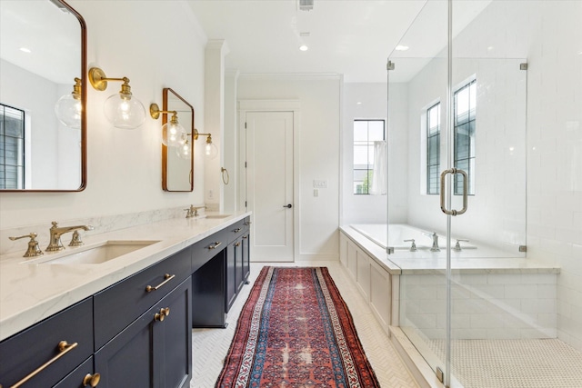 bathroom with a sink, a bath, and a stall shower