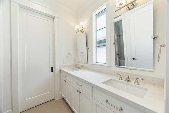 full bath with crown molding, a sink, plenty of natural light, and double vanity