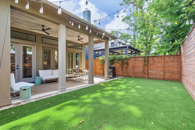 exterior space with a fenced backyard, a ceiling fan, and a patio area