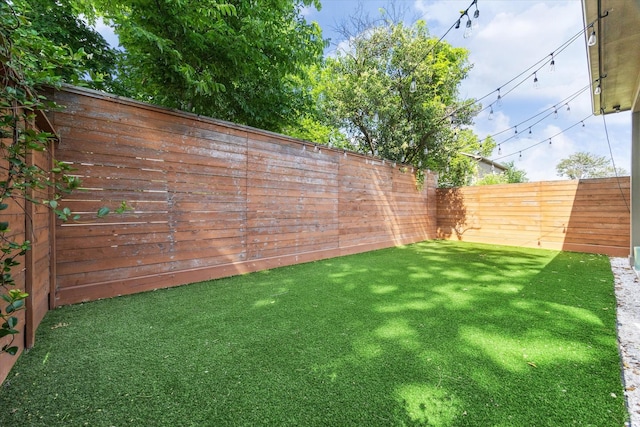 view of yard with a fenced backyard