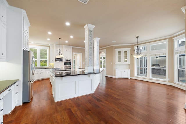 5811 Cimmaron Creek Ct, Spring, TX 77379 - kitchen featuring white cabinetry, dark countertops, appliances with stainless steel finishes, and ornamental molding