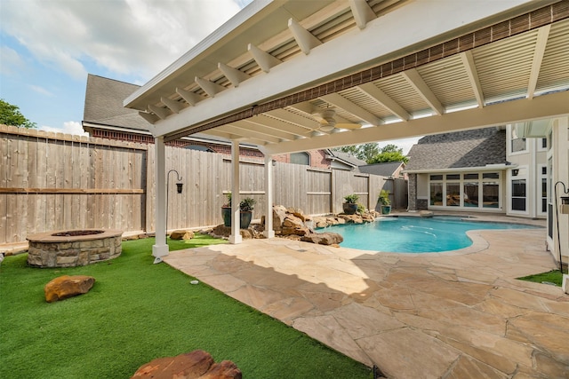 5811 Cimmaron Creek Ct, Spring, TX 77379 - pool featuring a fenced backyard, a lawn, a fire pit, and a patio area