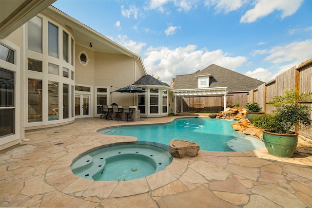 5811 Cimmaron Creek Ct, Spring, TX 77379 - view of swimming pool with a patio, a fenced backyard, a pool with connected hot tub, and french doors