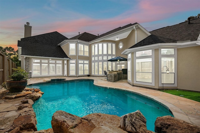 5811 Cimmaron Creek Ct, Spring, TX 77379 - pool at dusk featuring fence, an in ground hot tub, a patio area, and an outdoor pool