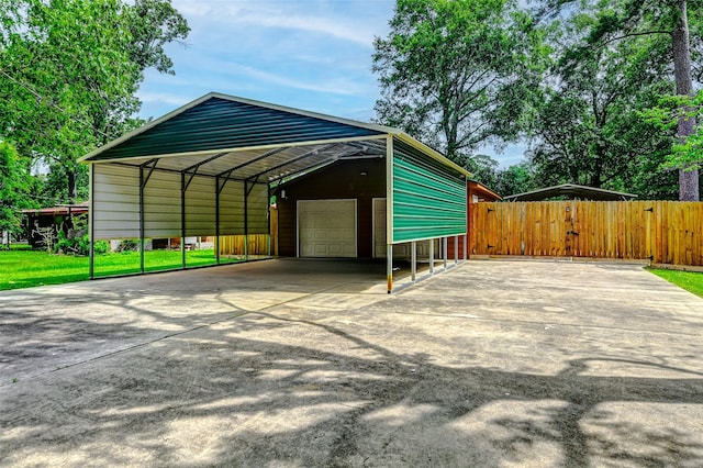 view of parking / parking lot with a garage, fence, and concrete driveway
