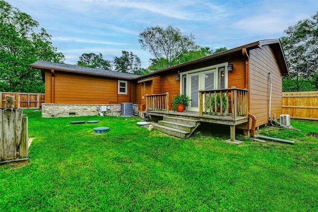back of house featuring fence, a yard, cooling unit, and a deck