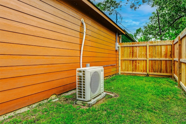 exterior space with ac unit and fence