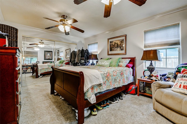 bedroom with ceiling fan, ornamental molding, and carpet