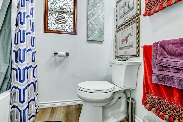 full bathroom featuring toilet, baseboards, curtained shower, and wood finished floors