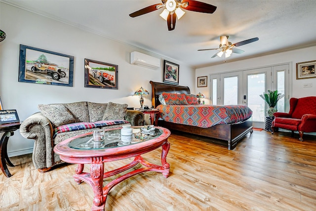 bedroom featuring crown molding, access to outside, french doors, wood finished floors, and a wall mounted AC