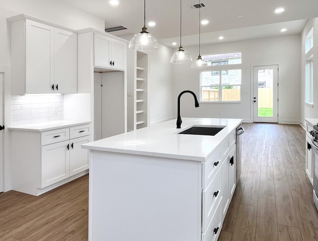 kitchen with recessed lighting, a sink, and wood finished floors