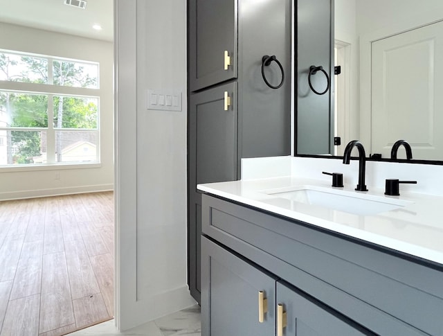 bathroom with recessed lighting, baseboards, visible vents, and vanity
