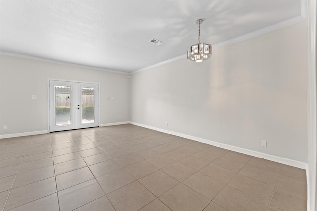 empty room with visible vents, ornamental molding, baseboards, and a chandelier