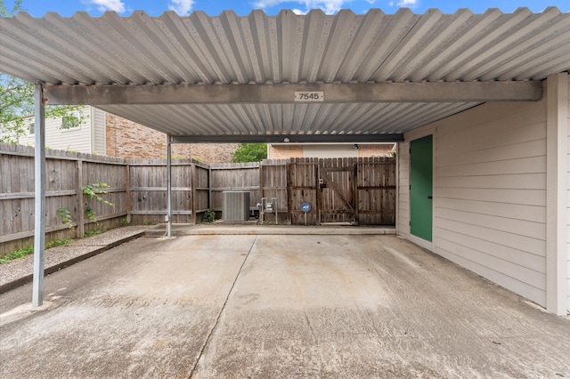 view of patio / terrace with central AC unit, fence, and a gate