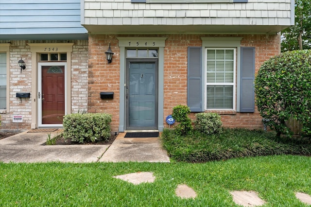 7545 Brompton St Unit 7545, Houston, TX 77025 - view of exterior entry featuring brick siding and mansard roof