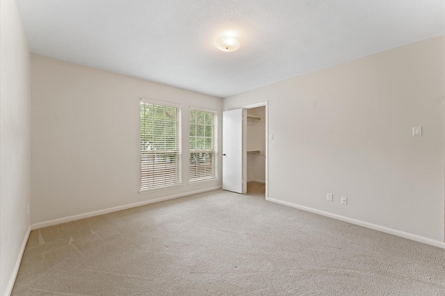 7545 Brompton St Unit 7545, Houston, TX 77025 - unfurnished bedroom with carpet, baseboards, a spacious closet, and a closet