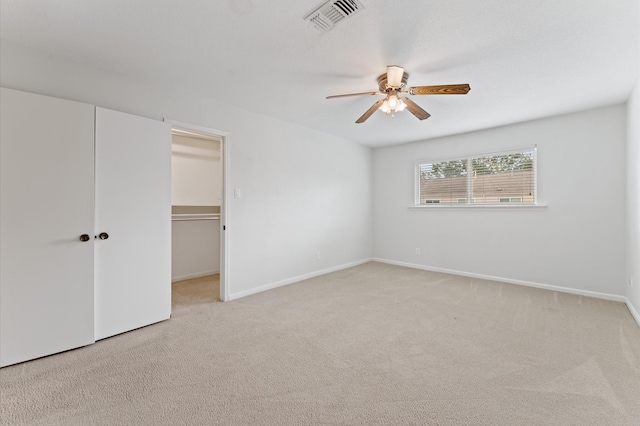 7545 Brompton St Unit 7545, Houston, TX 77025 - unfurnished bedroom with light colored carpet, a closet, a ceiling fan, baseboards, and a spacious closet