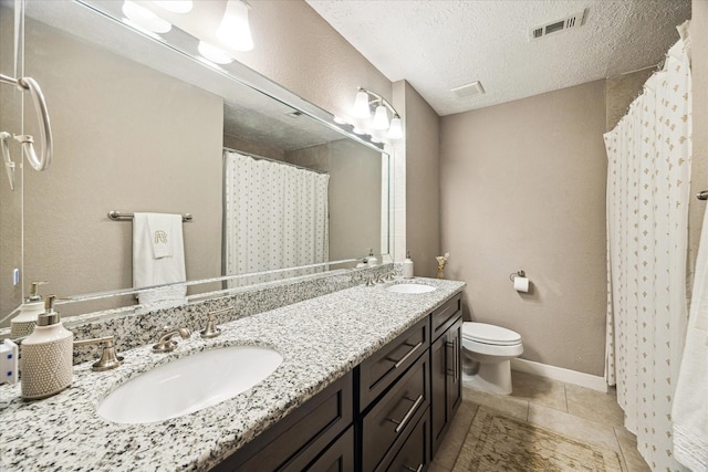 bathroom with toilet, tile patterned floors, visible vents, and a sink