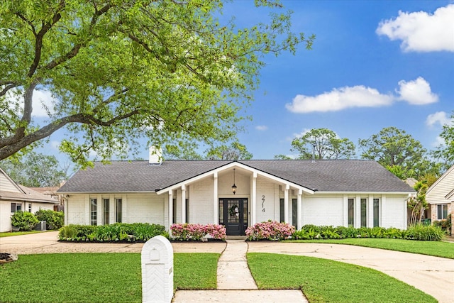 view of front of home with brick siding and a front yard