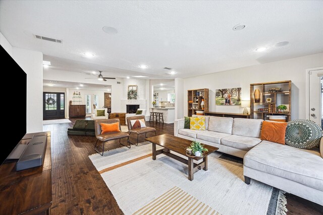 living area with recessed lighting, ceiling fan, visible vents, and wood finished floors