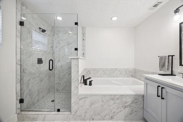 full bath with vanity, visible vents, a textured ceiling, a bath, and a marble finish shower
