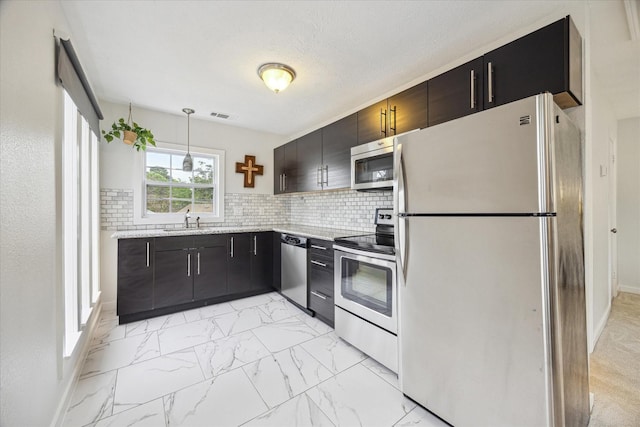 kitchen featuring visible vents, marble finish floor, a sink, appliances with stainless steel finishes, and backsplash