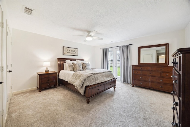bedroom featuring visible vents, a textured ceiling, light carpet, and access to exterior