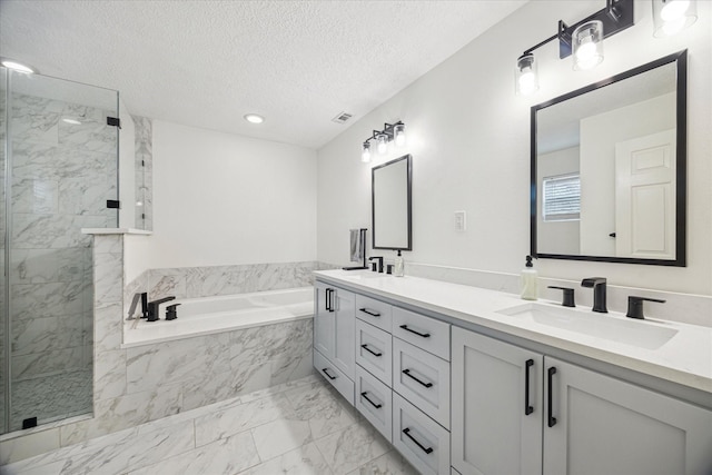 bathroom featuring a garden tub, visible vents, a sink, marble finish floor, and a marble finish shower